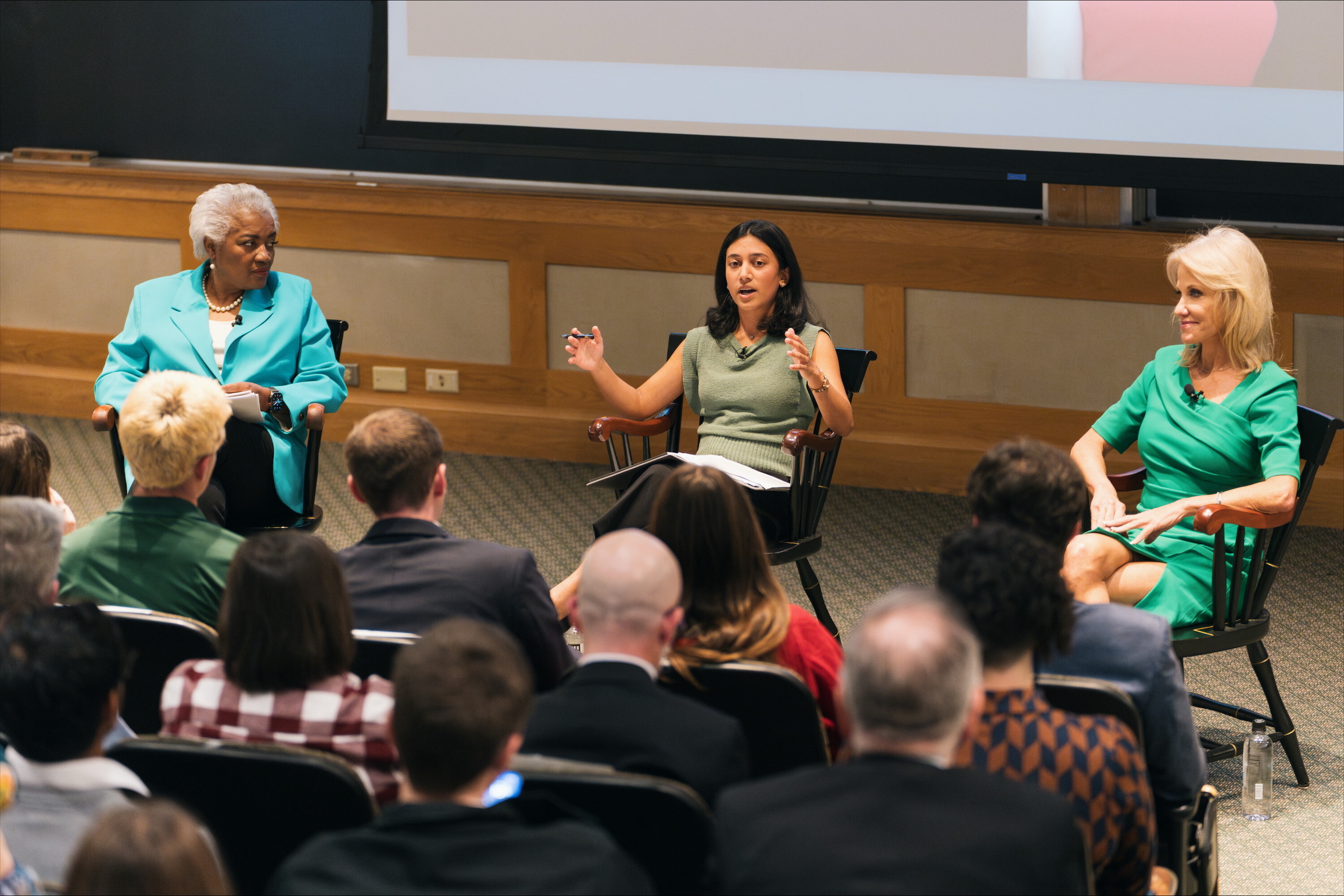 Three people on a stage having a discussion